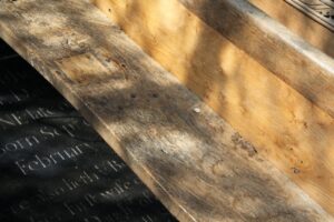 Image shows sunlight falling on medieval benches and inscribed gravestones inside the church